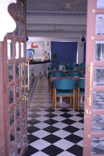 a restaurant with a black and white checkered floor at Hotel Darbargarh A Unit of Khamma Ghani A Boutique Hotel in Udaipur