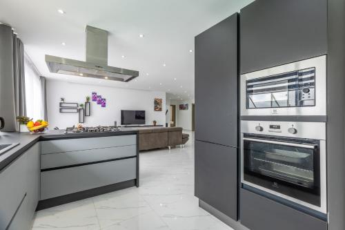 a kitchen with a stove and an oven in it at Luxury Penthouse for families only with Pool and Seaview in Ta Xbiex Malta in Taʼ Xbiex