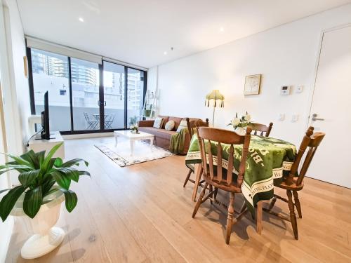 a living room with a table and a couch at Cozy Apartment at St Leonard in Sydney