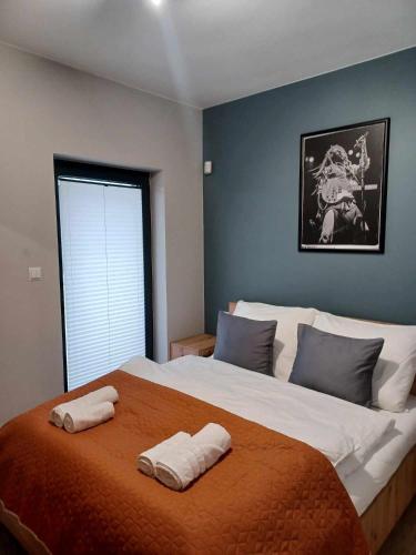 a bedroom with a large bed with two towels on it at Sosnówka - Wypoczynek in Sosnówka