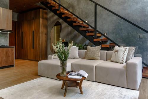 a living room with a white couch and a table at Sunny Cuddles in Canggu