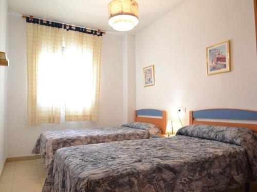 Ένα ή περισσότερα κρεβάτια σε δωμάτιο στο Apartamento Eco Dunas La Plaxa Riu