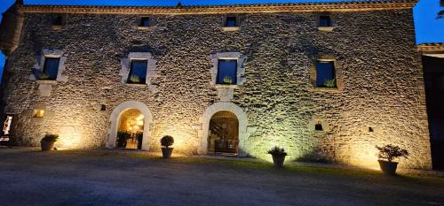a large stone building with windows and doors at Arcs De Monells - Adults Only in Monells