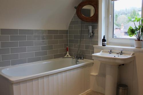 a bathroom with a sink and a bath tub and a sink at Lovely 3 bed condo in Reigate