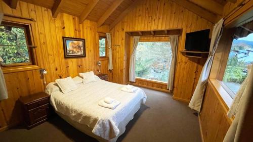a bedroom with a bed with towels on it at Apart Hotel del Pellin in San Martín de los Andes