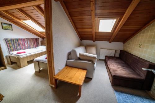 a living room with a couch and a table at Pension Arberwald in Bayerisch Eisenstein