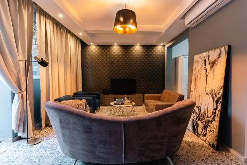a living room with a couch and a table at Penthouse Suite 9 at Palazzo Seraphim Boutique living in St Julians in St. Julianʼs
