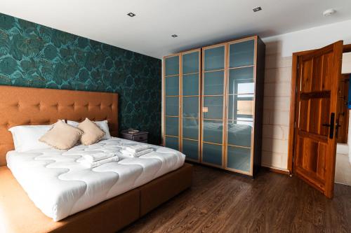 a bedroom with a large bed and a window at Penthouse Suite 9 at Palazzo Seraphim Boutique living in St Julians in St. Julianʼs