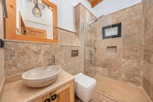a bathroom with a sink and a toilet at Kalamar Beach 5 in Kaş