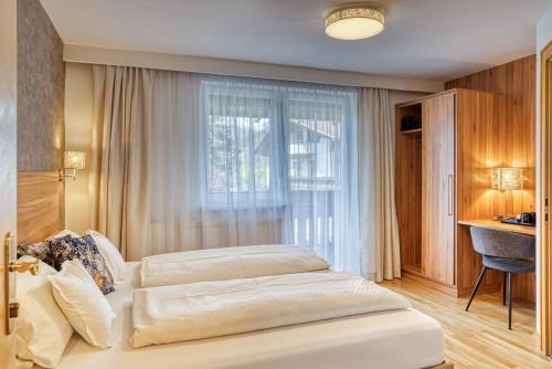 a bedroom with two beds and a window at Apart Winkler in Karres