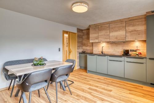 a kitchen and dining room with a table and chairs at Apart Winkler in Karres