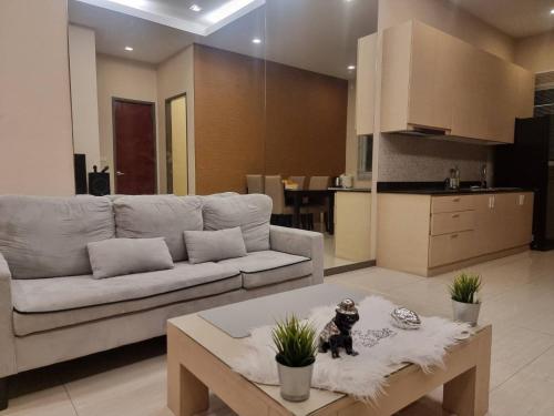 a living room with a couch and a coffee table at The Golfers in Jomtien Beach