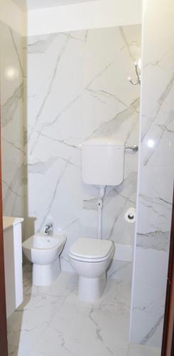 a white bathroom with a toilet and a sink at Ca Aisha Train Station Venice in Mestre