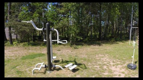 a group of exercise equipment in a field at Kaszuby wczasy u Danusi sauna i bania in Lipusz