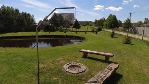 a park with a bench and a pond at Kaszuby wczasy u Danusi sauna i bania in Lipusz