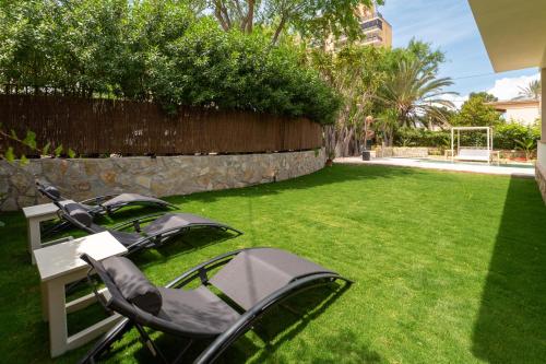 a golf cart sitting on the grass in a yard at VILLA Henry in Playa de Palma