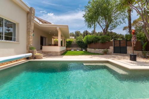 a swimming pool in the backyard of a house at VILLA Henry in Playa de Palma