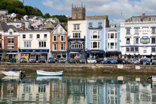 a city with boats in the water and buildings at Anchor Watch with Parking in Dartmouth