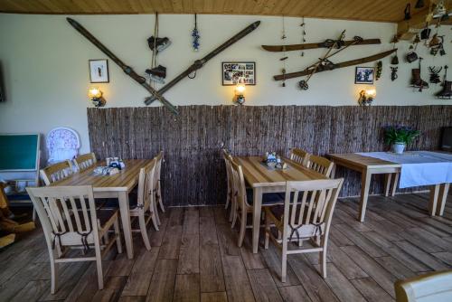 a dining room with wooden tables and chairs at Pension Arberwald in Bayerisch Eisenstein
