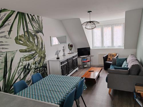 a living room with a couch and a table at La maison rouge in Le Guilvinec