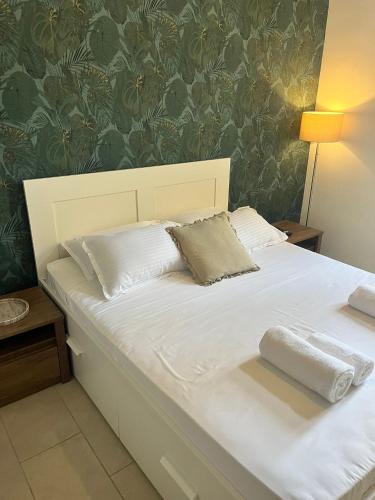 a bed with two pillows on it in a bedroom at Suite 3 at Palazzo Seraphim Boutique living in St Julians in St Julian's
