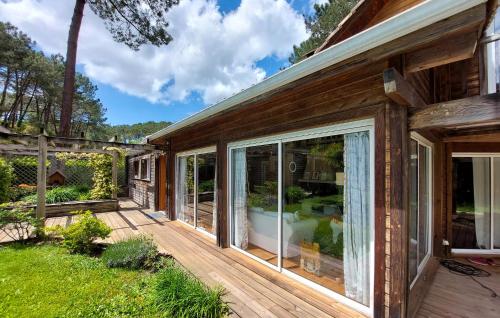 une maison avec des portes coulissantes en verre sur une terrasse dans l'établissement Stunning Home In Seignosse, à Seignosse
