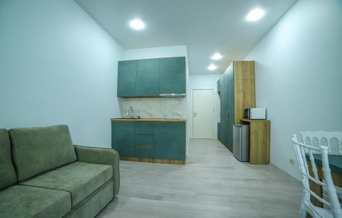 a living room with a couch and a kitchen at Bamboo Beach Cixisdziri in Tsikhisdziri