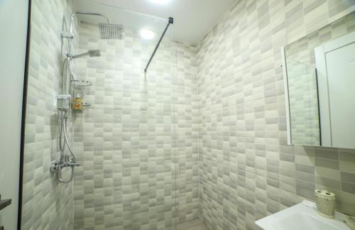 a bathroom with a shower and a sink at Bamboo Beach Cixisdziri in Tsikhisdziri