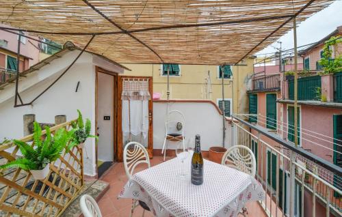 a balcony with a table with a bottle of wine on it at Pet Friendly Apartment in Monterosso al Mare