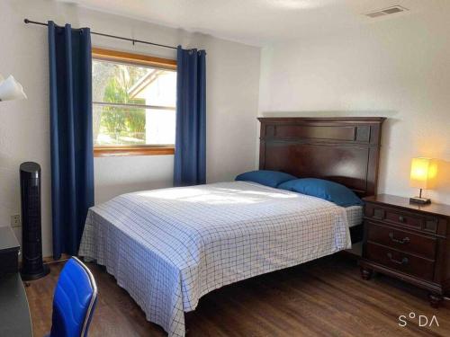 a bedroom with a bed and a dresser and a window at Family Vacation Home with Pool in Sarasota
