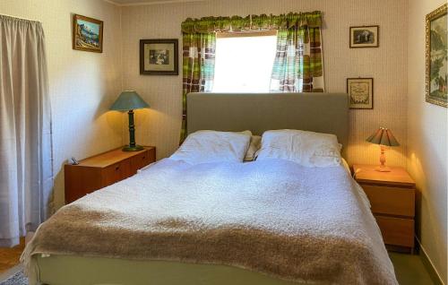 a bedroom with a large bed and a window at 4 Bedroom Gorgeous Home In Valldal in Valldal