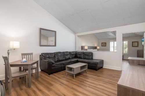 a living room with a couch and a table at Naples Park Central Hotel in Naples