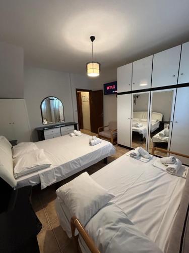 a hospital room with two beds and a mirror at K. Villa - Golden Beach in Chrysi Ammoudia