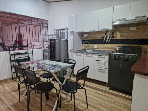 a kitchen with a table and chairs and a stove at La Alborada Casa boutique in Villavicencio