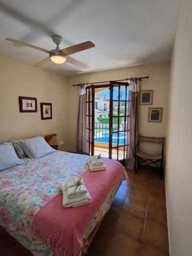 a bedroom with a bed with towels on it at Lluna Beach Bará in Roda de Bará