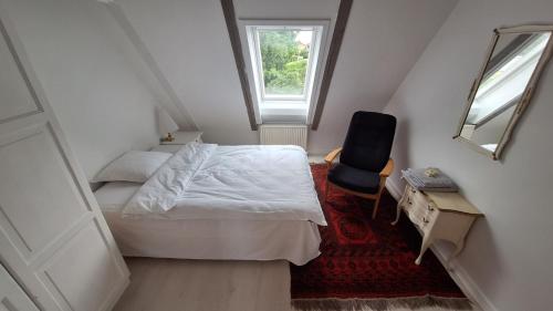 a small bedroom with a bed and a window at Room in Ubby (Near Kalundborg) in Kalundborg