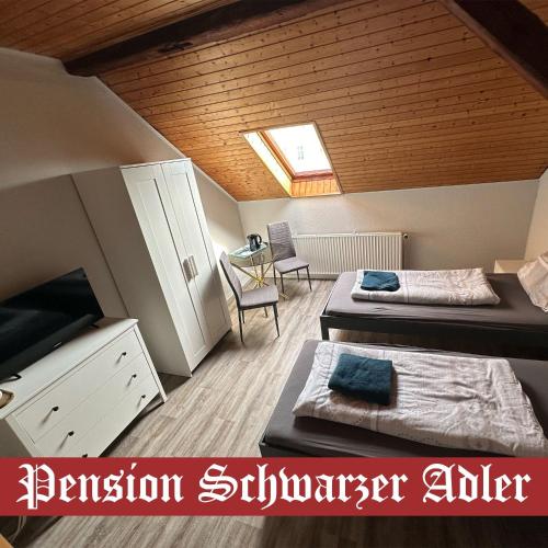a room with two beds and a room with a window at Pension Schwarzer Adler 