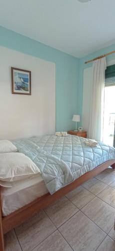 a large bed in a bedroom with a window at THALASSA - 2 Bedroom seaside appartment in Polychrono