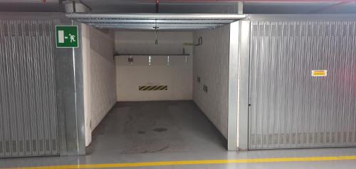 an empty hallway in a building with white walls at Casa di Fausto - CityLife Apartment in Milan