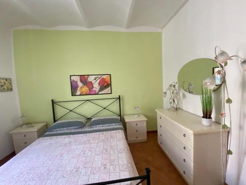 a bedroom with a bed and a dresser at Urban garden in Manciano