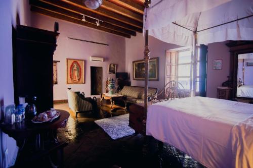 una camera da letto con un letto e un soggiorno di Casa Del Coleccionista a Puebla