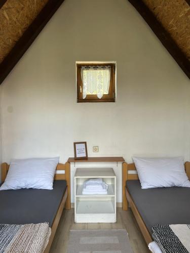 a room with two beds and a mirror on the wall at Camping Lukač in Kutina