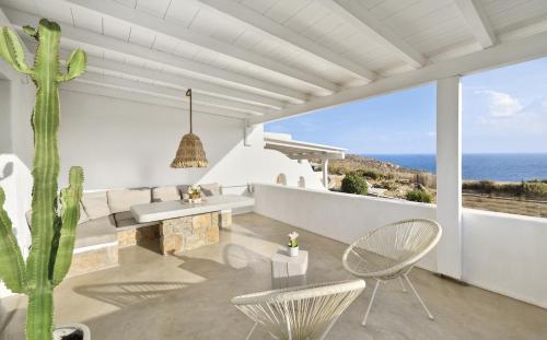 a living room with a view of the ocean at VLIA MAR Myconian Residences in Kalafatis