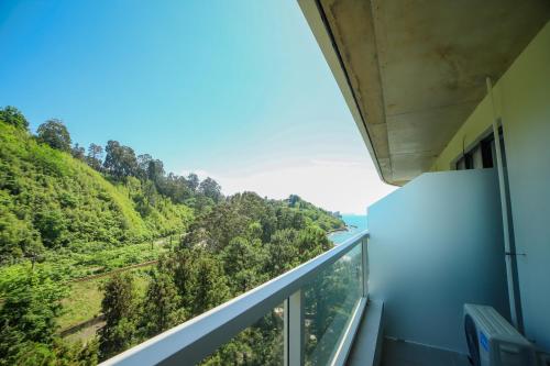 a balcony with a view of a forest at Bamboo Beach Cixisdziri in Tsikhisdziri