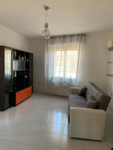 a living room with a couch and a tv at Nonna Pippi in Oristano