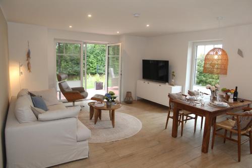 a living room with a couch and a table at Sieltied in Greetsiel