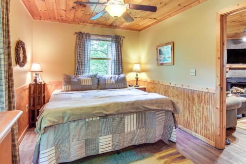 a bedroom with a bed and a ceiling fan at Charming Fox Den Cabin in Whittier with Hot Tub! in Whittier