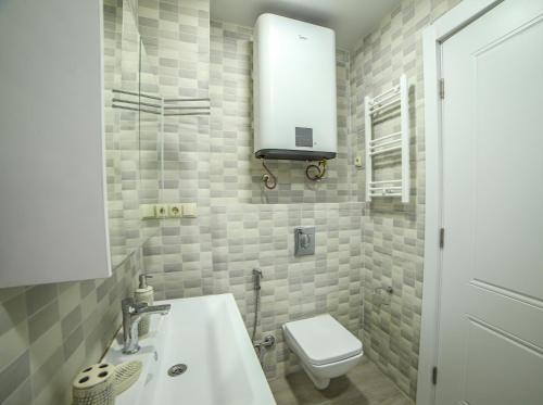 a small bathroom with a sink and a toilet at Bamboo Beach Cixisdziri in Tsikhisdziri