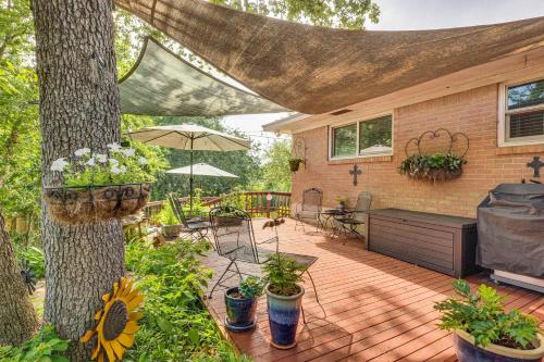 a backyard with a tree and a wooden deck at Lovely Bryan Home with Deck - 4 Mi to Kyle Field! in Bryan