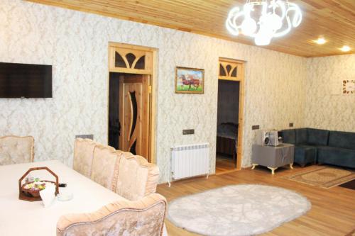 a living room with a table and a couch at Famili home in Ganja